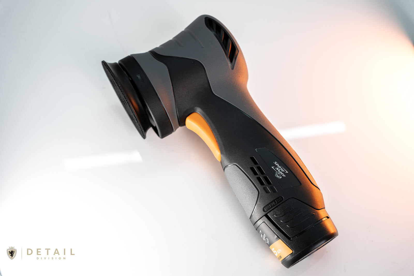 Black and orange car detailing tool on a white background