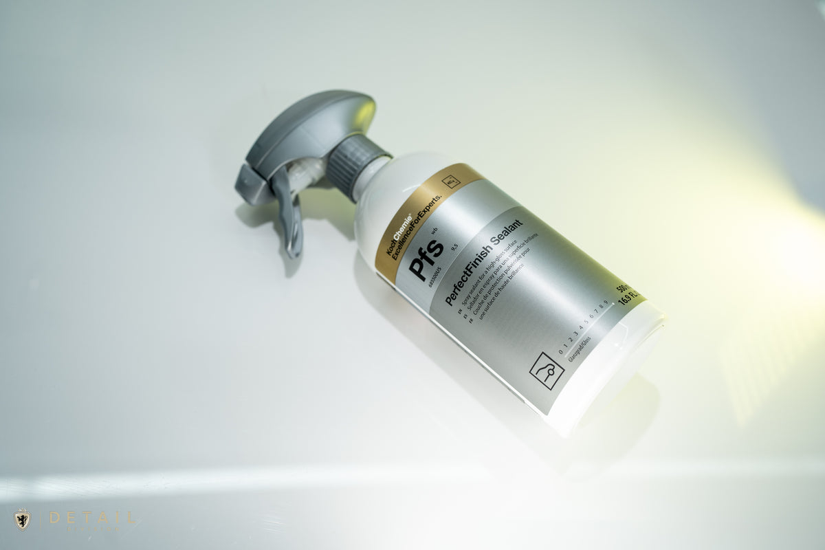 A bottle of Pfs Professional Solution by Detail division, featuring a white bottle with a metallic silver label and a gray spray nozzle, set against a bright, reflective white background.