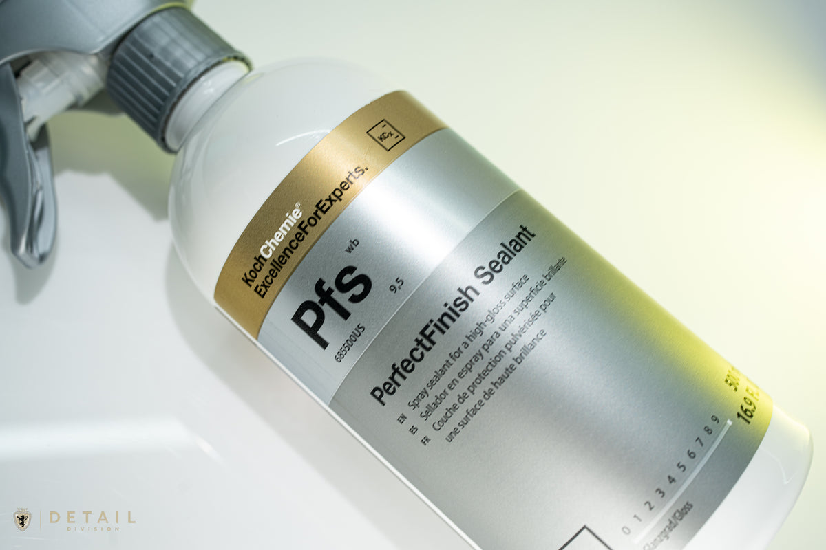A close-up of a spray bottle of Kock Chemie Pfs PerfectFinish Sealant, showing the white bottle, gray spray trigger, and a metallic silver and gold label.
