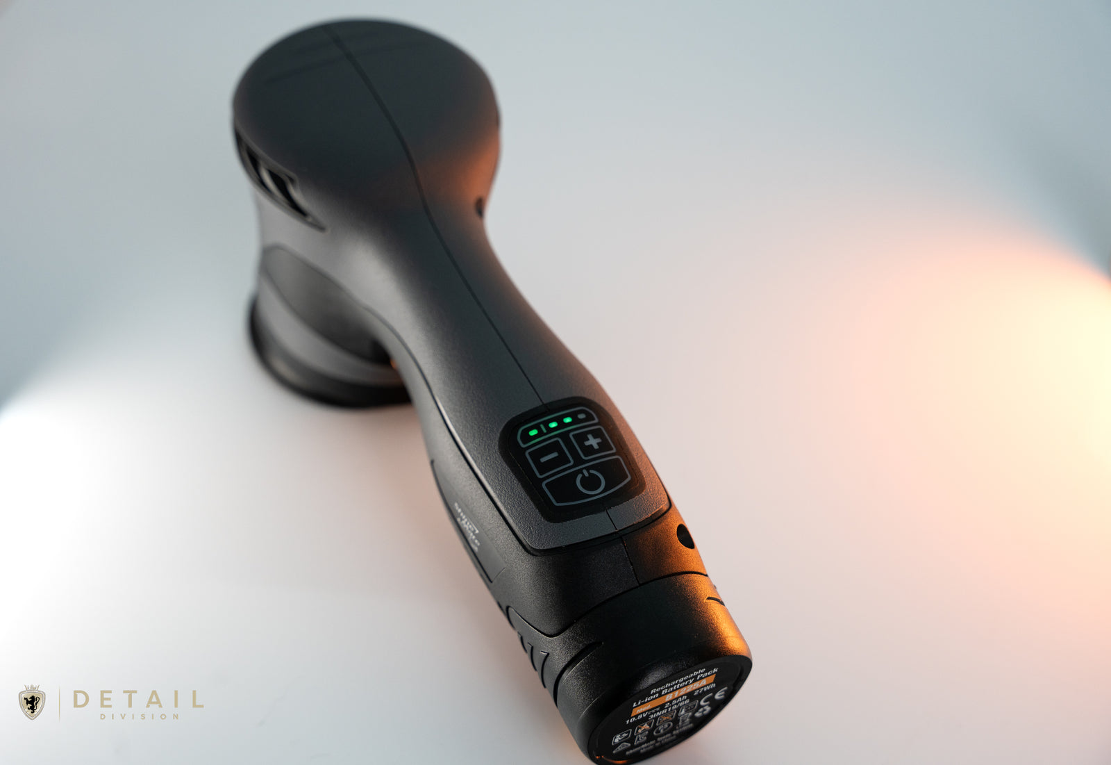 Black handheld device with control panel on a white background