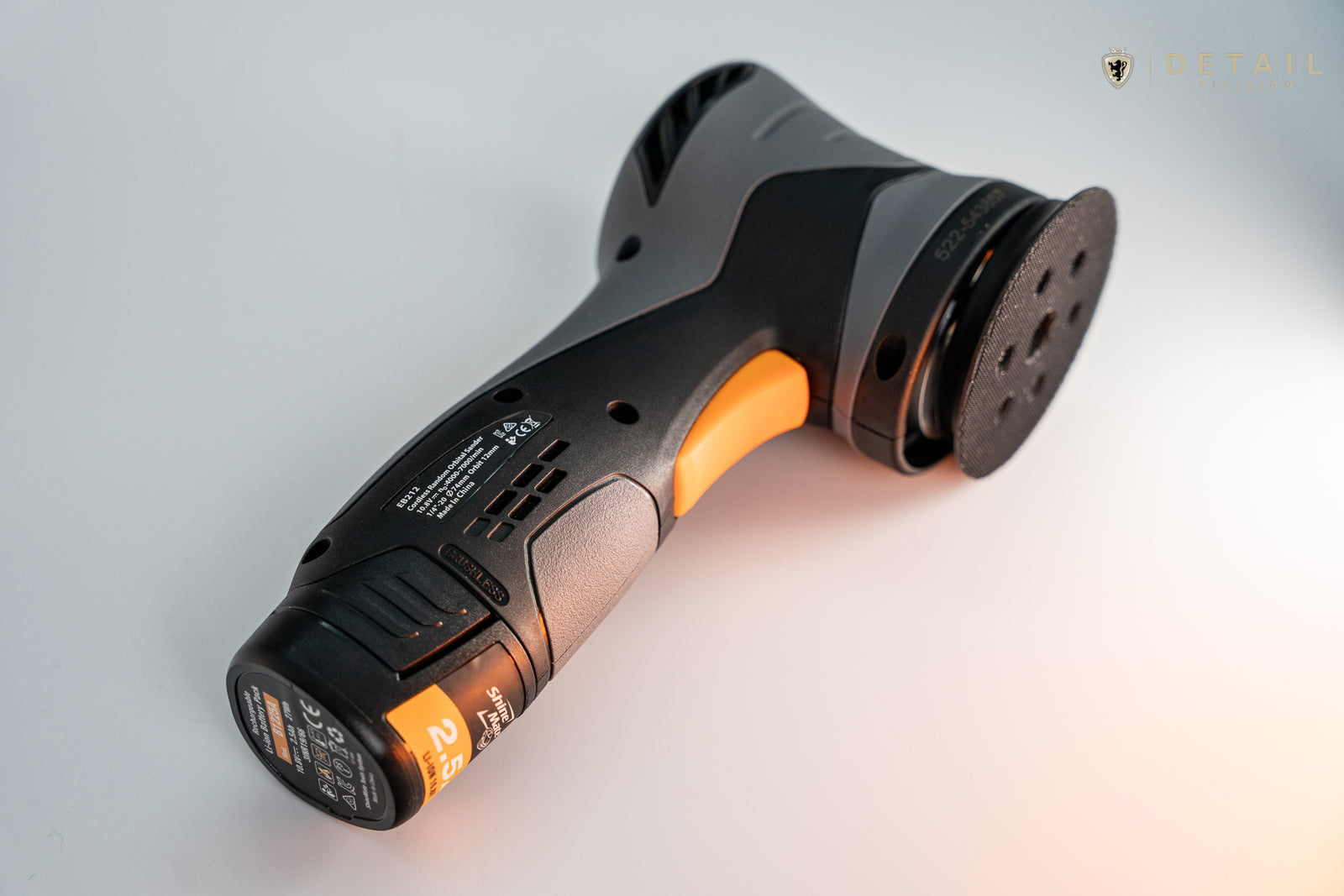 Close-up of a power tool handle with visible branding on a light background